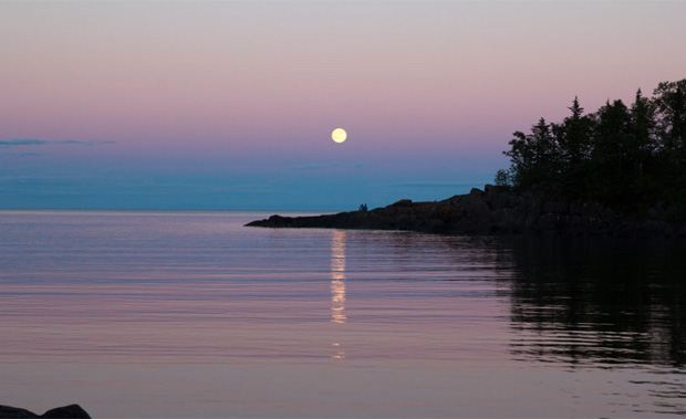 Full moon rising at sunset