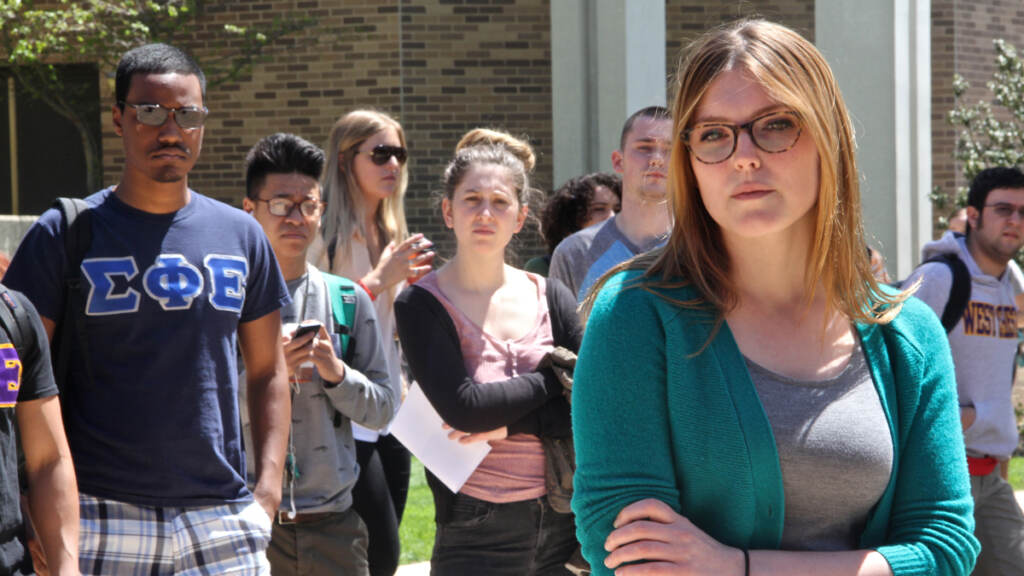West Chester junior Shannon Bertoni (right) tells her story of sexual assault to a gathering of students and media during a rally on the campus quad. (Emma Lee/for NewsWorks)