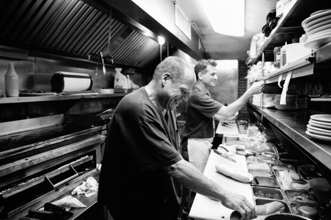 Wayne has been a cook at Little Pete’s for more than 14 years. He says, “I’ve seen everything in here.” (Neal Santos/WHYY)