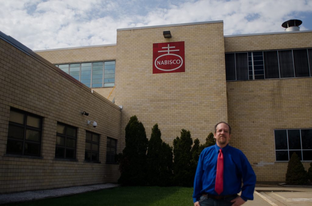 Ross Feinberg poses in front of the shuttered Nabisco Factory on Roosevelt Boulevard. It closed in 2015. (Alex Lewis/Every ZIP gPhiladelphia)