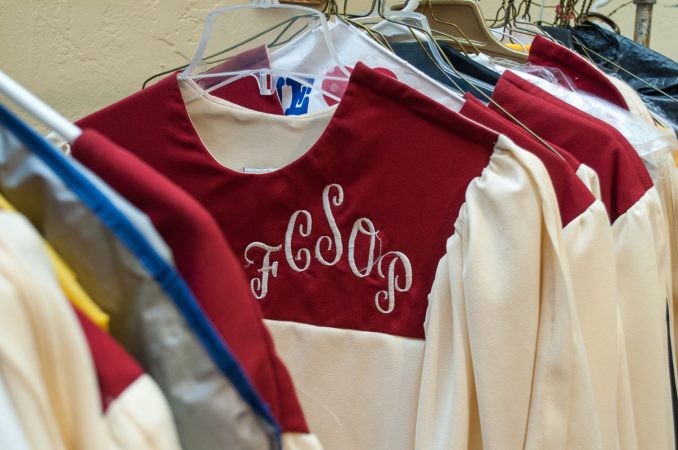 Church robes embroidered with the lettering that represents the words “Faith Chapel Sanctuary of Praise.”