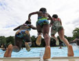 Kids jump into a pool