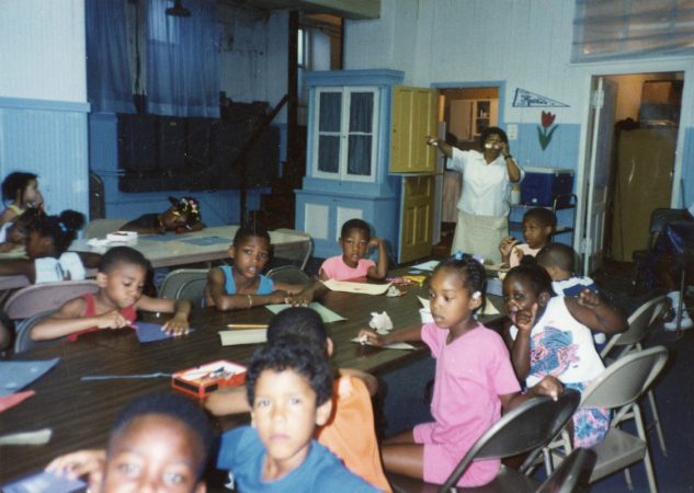 Neighborhood kids do arts and crafts at a makeshift community center in the basement of Disney Church in Jewtown. The parents of the community worked tirelessly to keep their children busy, productive and safe despite having little money. (Courtesy of Diane Precht)