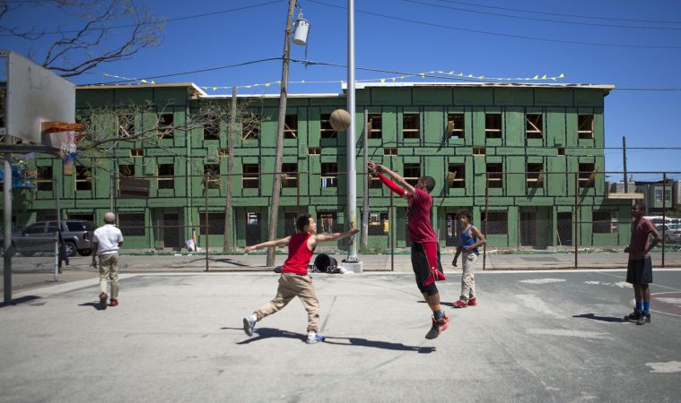 Neighborhood kids play basketball at Jewtown Park. Across from the park is a new development of low income housing. The development is receiving mixed views from residents both past and present. The kids say they do not like the neighborhood because there are a lot of drugs and violence. (Photo by Jessica Kourkounis)