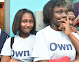 a young woman of color smiles at the camera