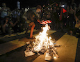 a protestor burns an American flag
