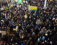 a crowd protests Trump's immigration ban