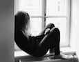 a girl sitting in a windowsill