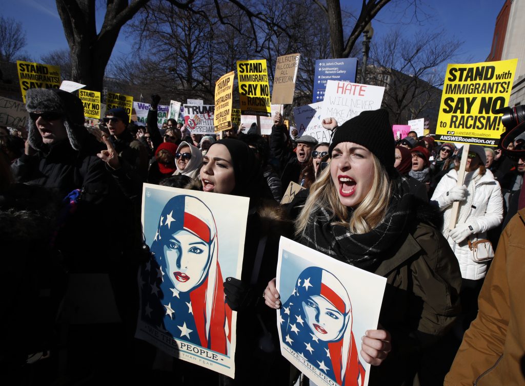 Martha Obermiller Martha Obermiller of Denver, right, chants during a rally protesting the immigration policies of President Donald Trump, near the White House in Washington, Saturday, Feb. 4, 2017.