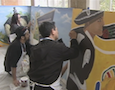 artists painting a mural