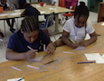 two students working with clay
