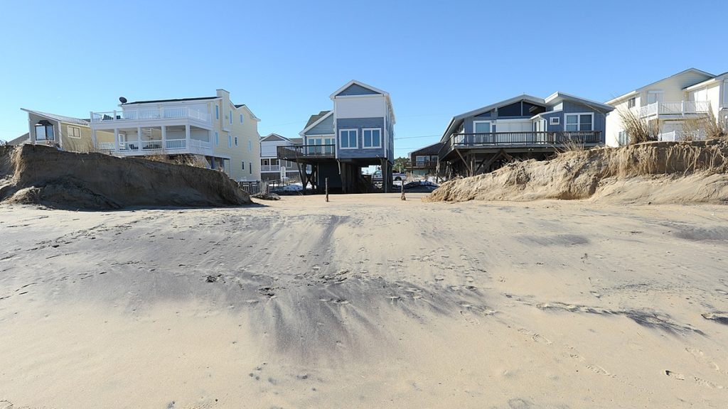 012416-storm-damage-bethany-cs-8263-1 Clean up has started even as flood waters still remain on the streets in Bethany Beach from the Winter Storm that came throughout the Coastal area on Friday & Saturday & Sunday, January 22-24.Delaware Gov. Jack Markell visited the area with U.S. Senator Tom Carper and other State Officials to view the damage and dune breeches. (Chuck Snyder/for NewsWorks)