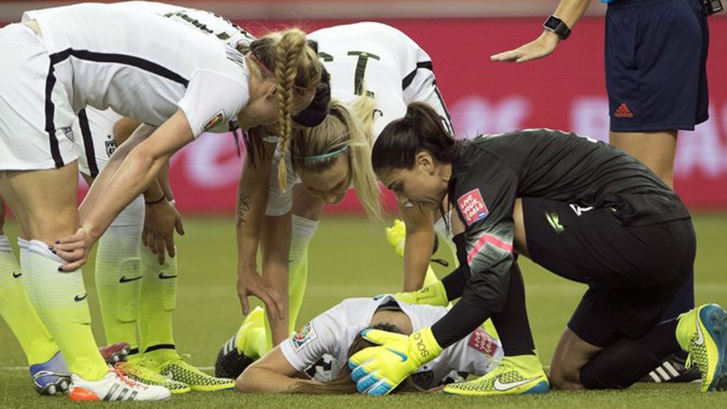 02longman-master675 Teammates tend to Morgan Brian, who collided with Alexandra Popp of Germany during the Women's World Cup semifinal on Tuesday. (Ryan Remiorz/The Canadian Press, via Associated Press)
