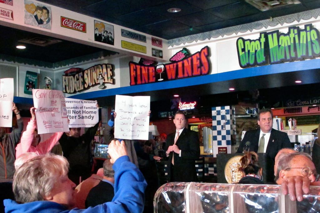 0ofrzchp Gov. Christie (back right) looks away from protesters in Seaside Heights