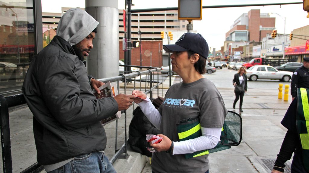Patty DiRenzo distributes information about a New Jersey law that protects those who report drug overdoses from prosecution for drug crimes. DiRenzo's son died of an overdose in 2010. (Emma Lee/WHYY)