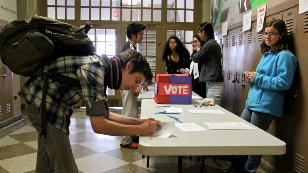 11-3 A student stops in the hallway at Masterman High School to vote in a mock Republican primary. (Emma Lee/WHYY)