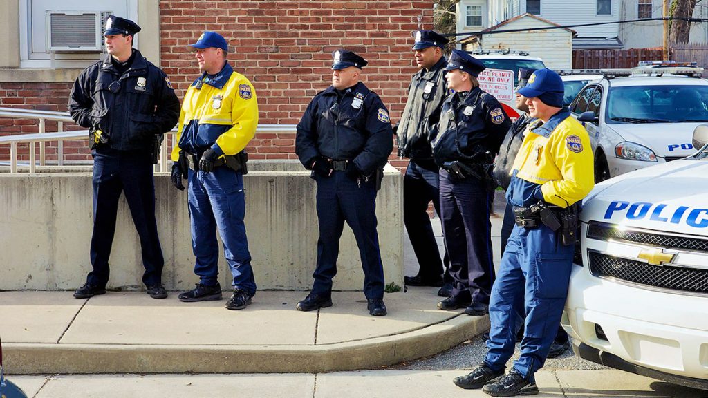  Officers stand near the 14th district police station on Haines Street in Philadelphia. (Bas Slabbers/for NewsWorks, file) 