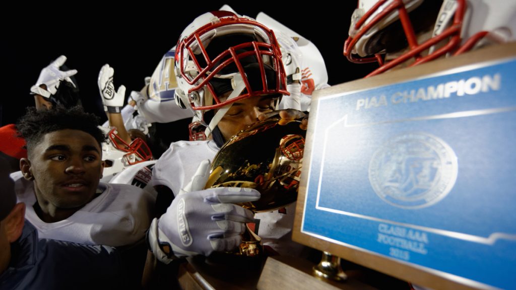 The PIAA AAA State Championship trophy is kissed by the players. (Bastiaan Slabbers/for NewsWorks)