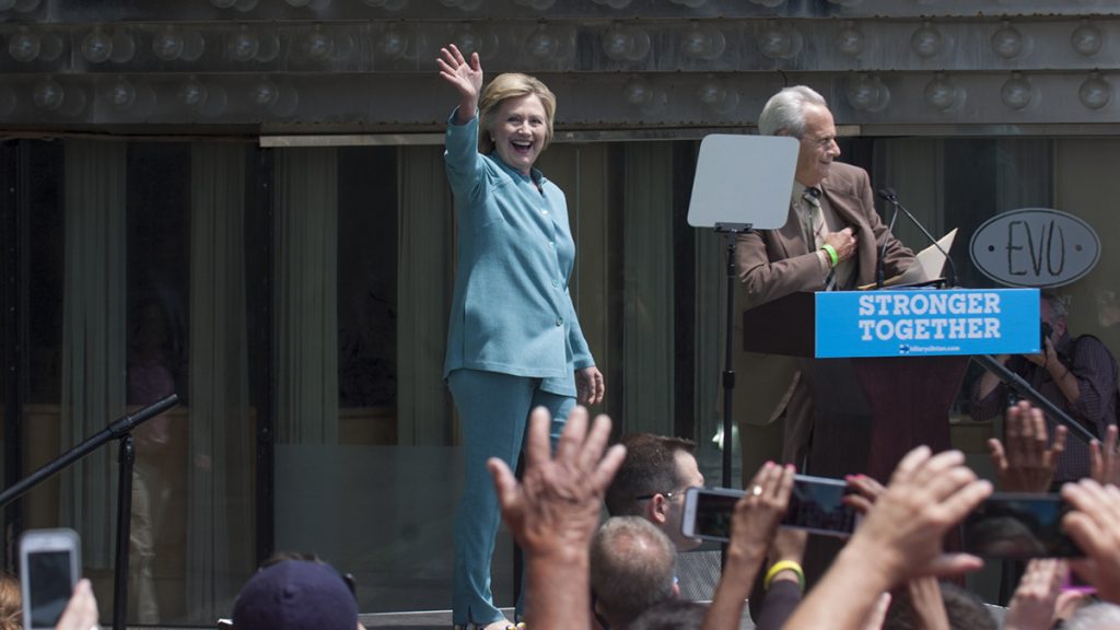 Hillary Clinton waves to the crowd on the Atlantic City boardwalk before a speech about Donald Trump's business record in that city. (Anthony Smedile for NewsWorks)