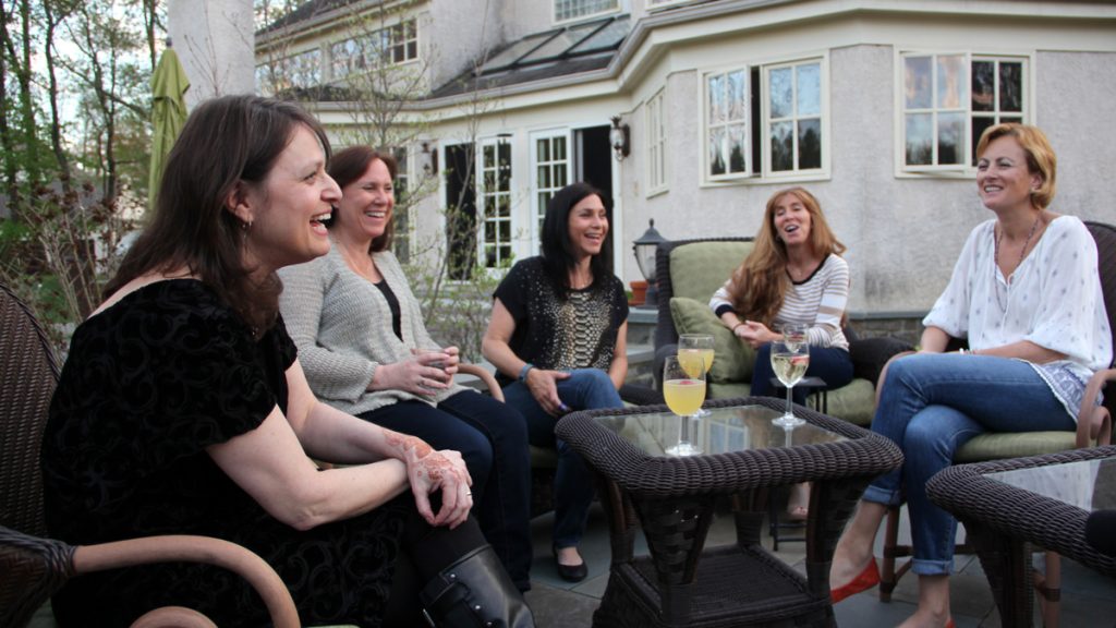 2-10 Book club members gather on the patio around author Nomi Eve. (Emma Lee/WHYY)