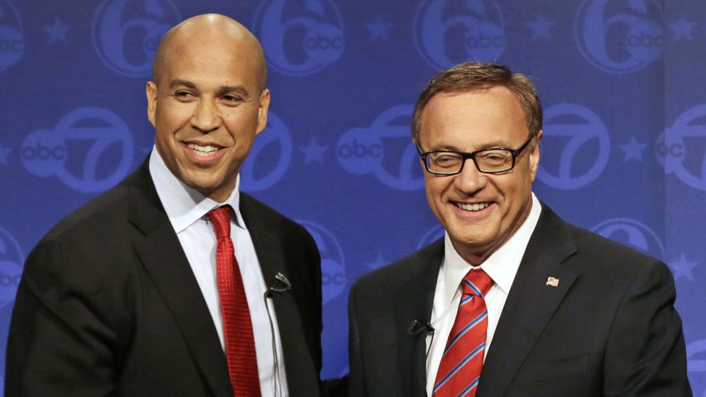 The final U.S. Senate debate between Cory Booker (left) and Steve Lonegan is tonight at Rowan University. (AP Photo/Mel Evans)