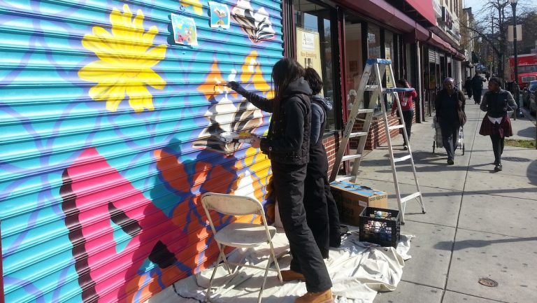  Kala Hagopian and Ali Williams painting the Acclaim Academy grates in Germantown. (Aaron Moselle/WHYY) 