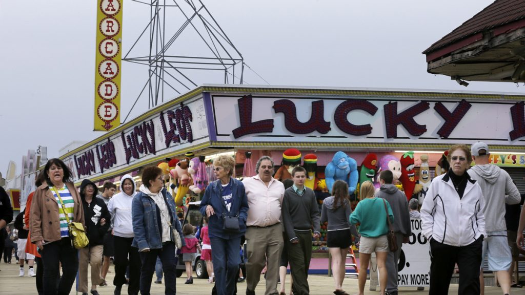  People walk past open attractions along the rebuilt boardwalk in Seaside Heights, N.J., Sat, May 18, 2013. (AP Photo/Mel Evans) 