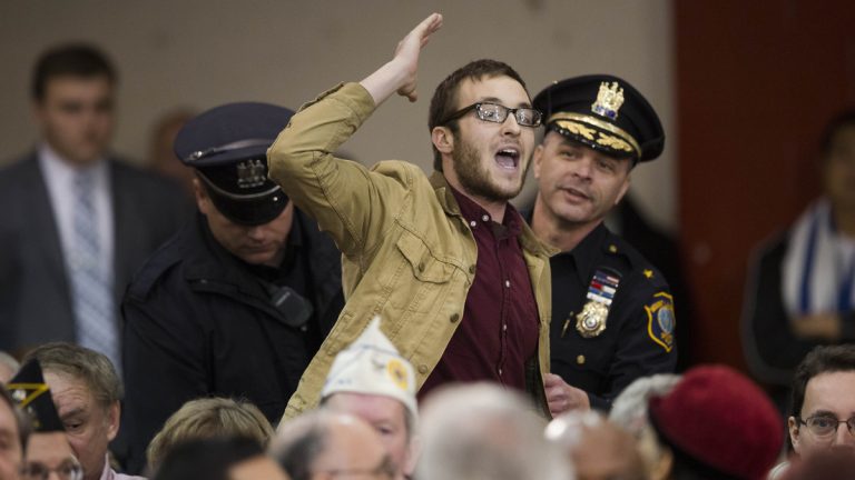  Rowan U student Michael Brein shouts at Gov. Christie, not pictured, as he is removed from a town hall meeting. (AP Photo/Matt Rourke) 
