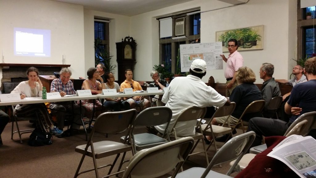 20140702_194832 Zoning attorney Bill Curr presents revised building plans to West Mt. Airy Neighbors members and residents at Wednesday's meeting. (Queen Muse/for NewsWorks)