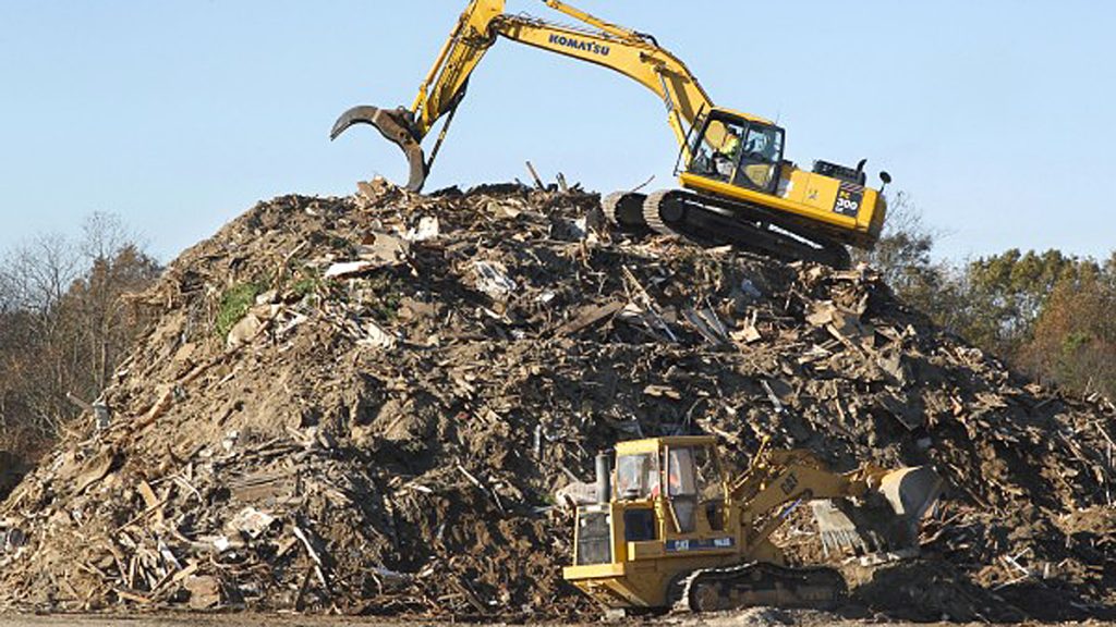 20140708-big-debris-pile-1200 Heavy equipment operators work on a mountain of debris left by Superstorm Sandy. (Mel Evans/AP File Photo)