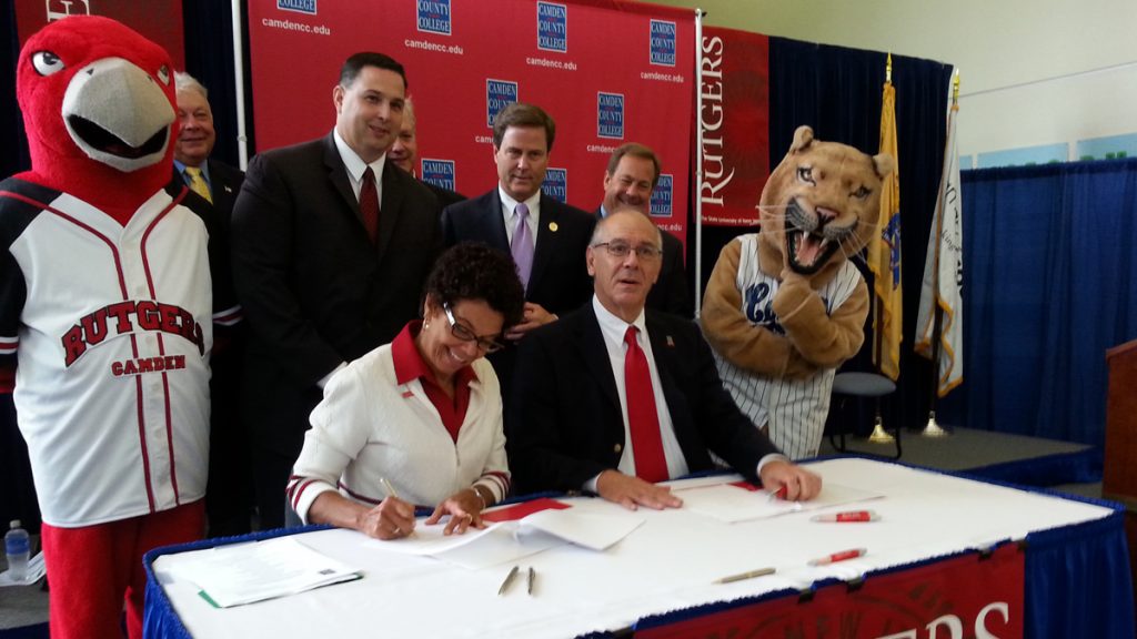 20140929_135124 Rutgers Camden Chancellor Phoebe Haddon signs the agreement Monday. (Tom MacDonald/WHYY)