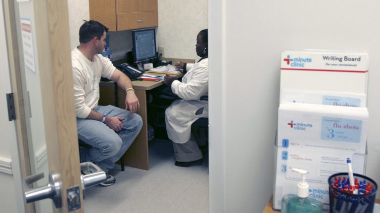  Shanda Johnson, right, a nurse practitioner, interviews patient Bill Gilligan at a MinuteClinic at the CVS drug store in North Brunswick, N.J., (AP Photo/Mike Derer) 