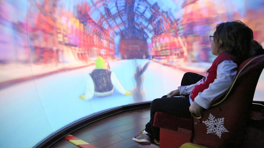 20141129-santa-6 8-year-old Lily thought it was 'awesome' watching a 4D story of Shrek and Donkey traveling to the North Pole (Natavan Werbock/for NewsWorks)