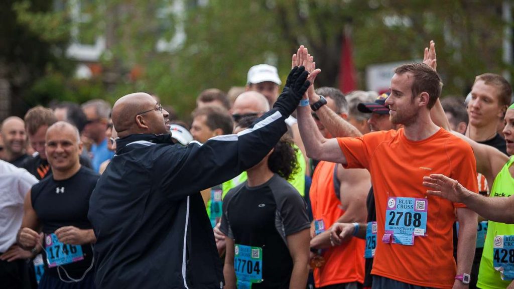 2014bsr_20140504_1524575345 Philadelphia Mayor Michael Nutter high fives runners before the start of the 2014 Broad Street Run. (Brad Larrison/for NewsWorks)
