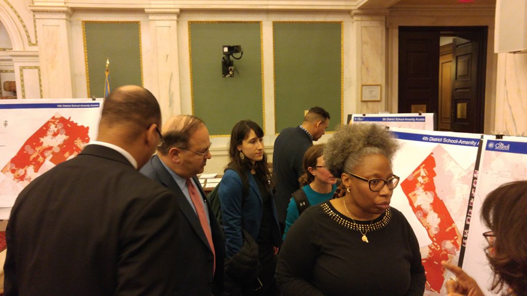 Philadelphia  Councilman Allen Domb and others look at maps showing potential locations where children could get a meal during a snowstorm.(Tom MacDonald/WHYY)