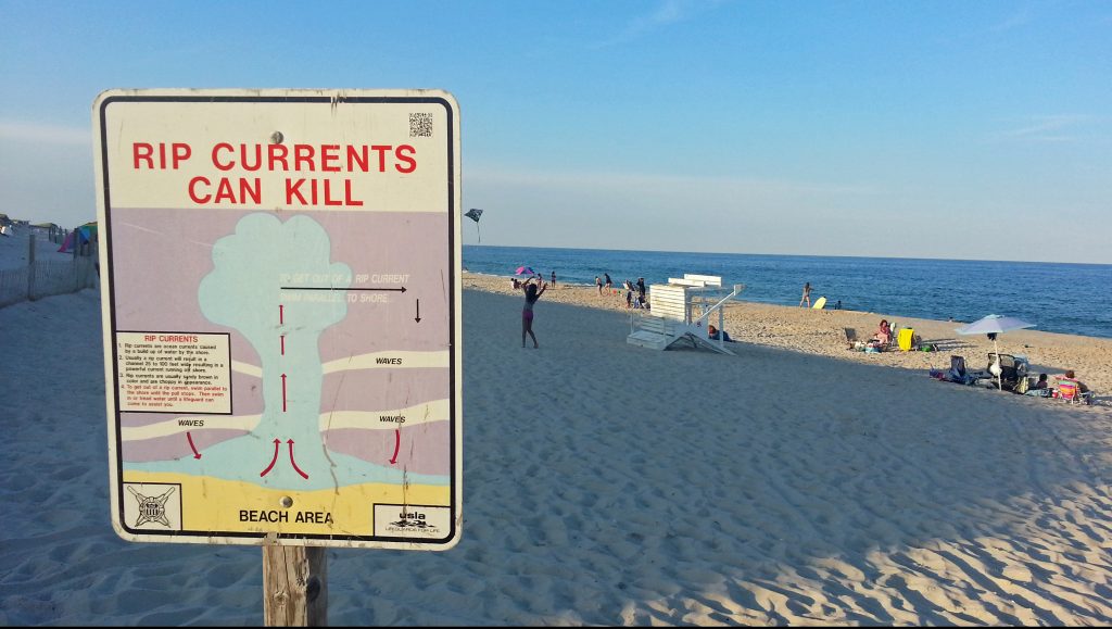 20160803-rip-current-sign-1200 A sign in Cape May instructs swimmers caught in a rip current to swim parallel to the beach to escape. (Alan Tu/WHYY)