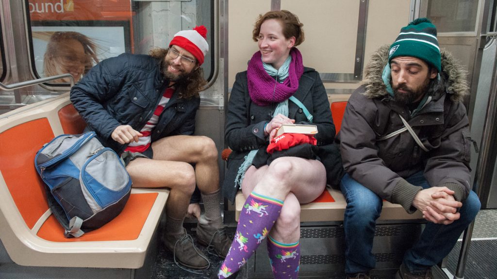 Friends who identified themselves as Waldo (left) and Koryn (center) participate in the  No Pants Subway Ride on the Broad Street line. (Jonathan Wilson for Newsworks)
