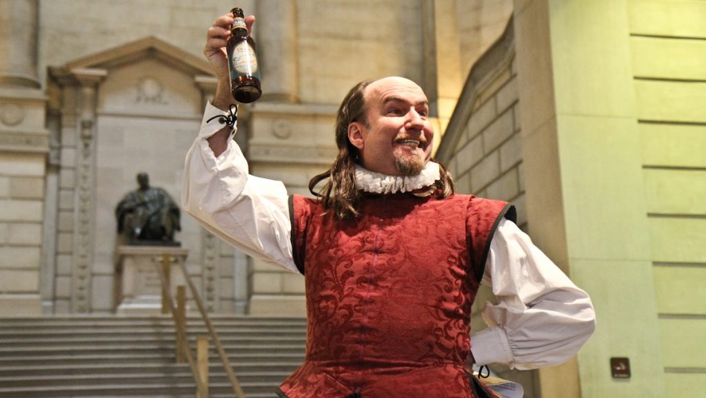 450-1-of-1-5 Brian McCann, acting as Shakespeare at the Free Library of Philadelphia, declares Yards Brewing Company's Shakesbeer, an English-Style Session Ale, his favorite drink. (Kimberly Paynter/WHYY)