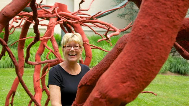 538a5449 Lisa Hanover, curator of 'Out of this World: Works by Steve Tobin' at the Michener Museum, stands amid a piece called 'Romeo and Juliet,' which consists of bronze casts of a tree root system. (Nathaniel Hamilton/for NewsWorks)