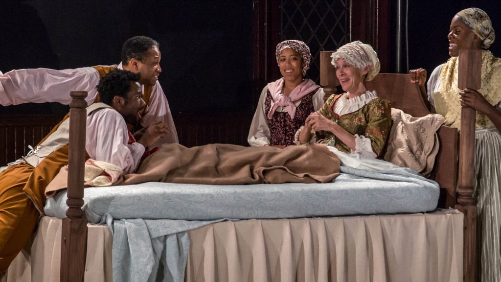 675-18 In Flashpoint Theatre's production of 'The Most Spectacularly Lamentable Trial of Miz Martha Washington,' from left: Darryl Gene Daughtry Jr., Steven Wright, Taysha Canales , and Jaylene Clark Owens surround Nancy Boykin as Martha Washington. (Image courtesy of Ian Paul Guzzone)