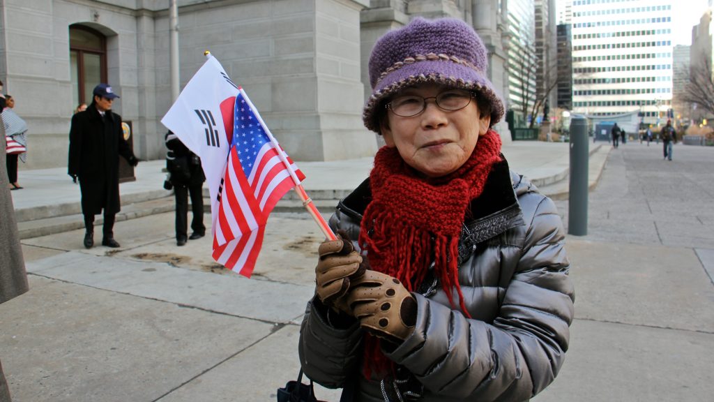 6leadjoo hwan yi Joo Hwan Yi of Philadelphia waves the flags of the United Statesa and the Republic of Korea to celebrate Korean American Day. (Emma Lee/WHYY)
