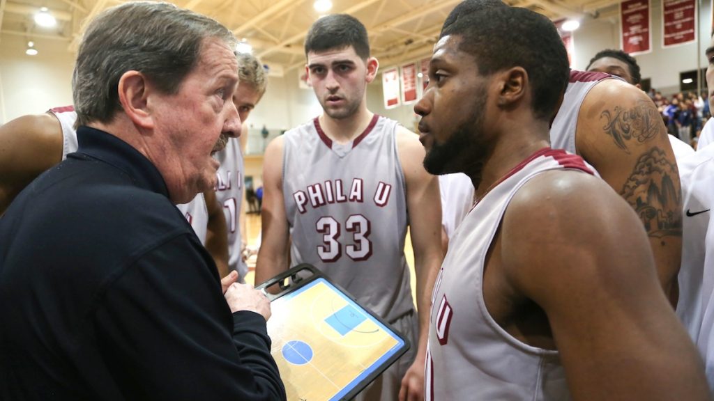 9-4 Coach Magee surrounded by his players strategizes for his 1000th win (Natavan Werbock/for NewsWorks)