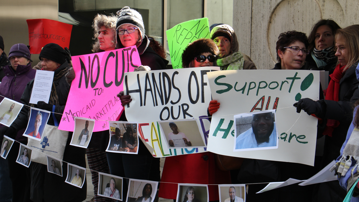 About two dozen protesters gather outside the Philadelphia office of U.S. Sen. Pat Toomey to voice their concerns about the repeal of the Affordable Care Act. Similar protests took place at the senator's offices in Allentown
