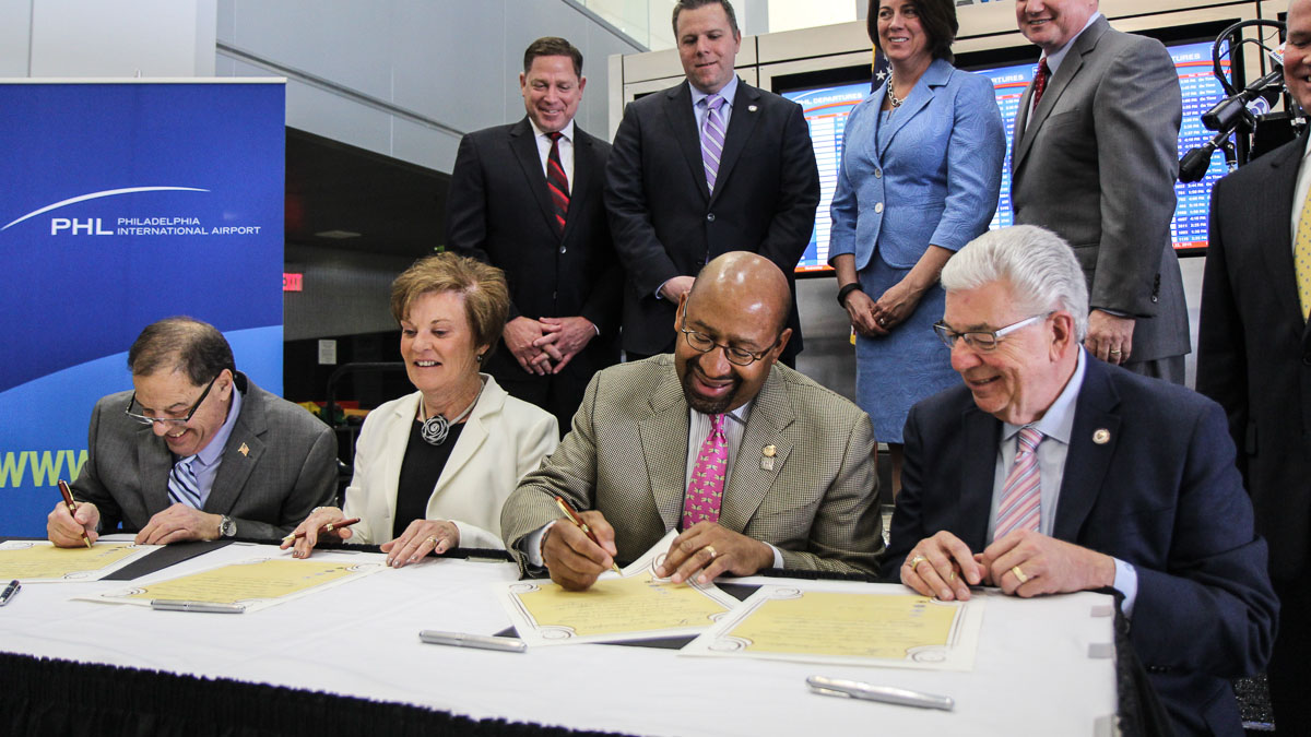  Tinicum Township Board of Commissioners president Thomas Giancristoforo, Interior School Board President Kathy Hauger, Philadelphia Mayor Michael Nutter and Delaware County Council Chairman Mario Civera sign documents symbolic of an agreement that resolves lawsuits over the Capacity Enhancement Program. (Kimberly Paynter/WHYY) 
