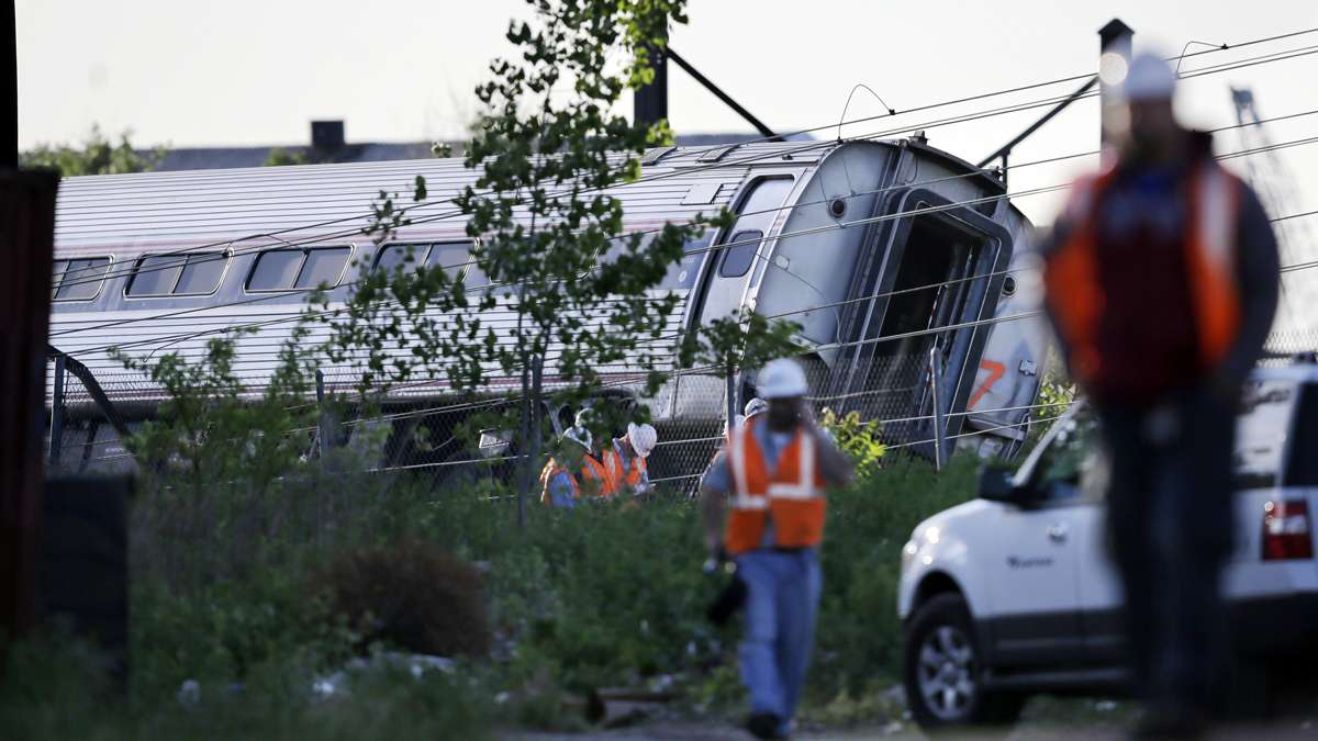  Emergency personnel walk near the scene of a deadly train wreck in Philadelphia. (Mel Evans/AP Photo) 