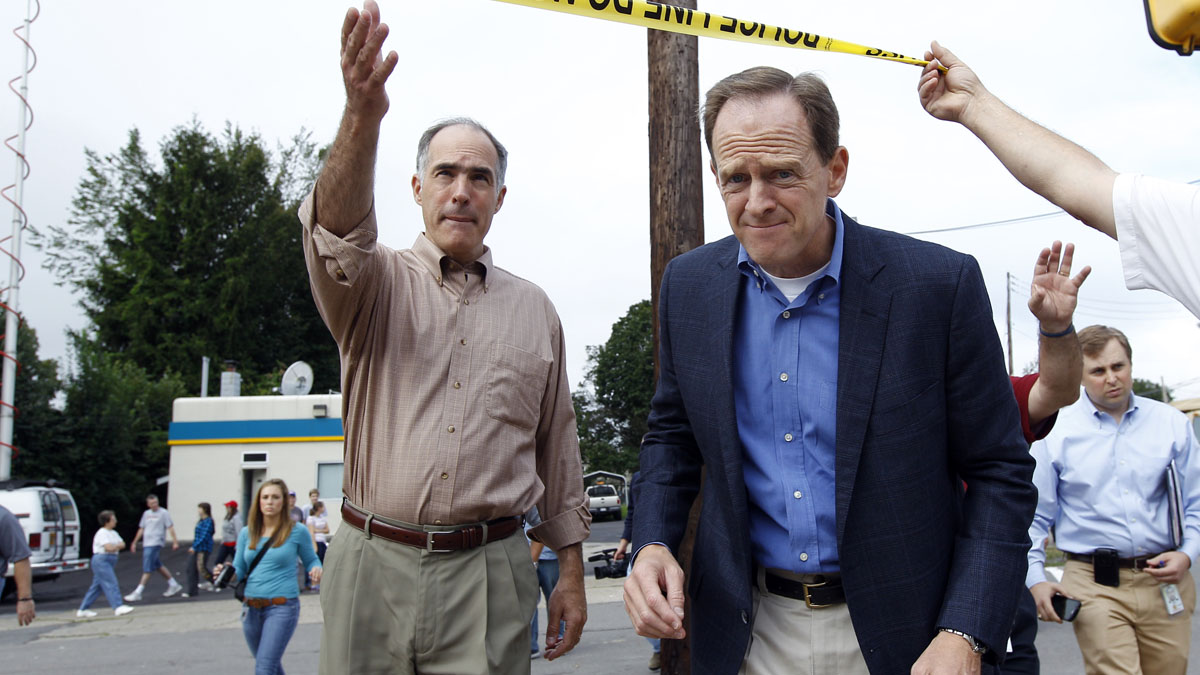  U.S. Sens. Bob Casey, left, and Pat Toomey say they have worked together on a number of issues, including this trip to inspect flooding damage in 2011. (AP file photo) 