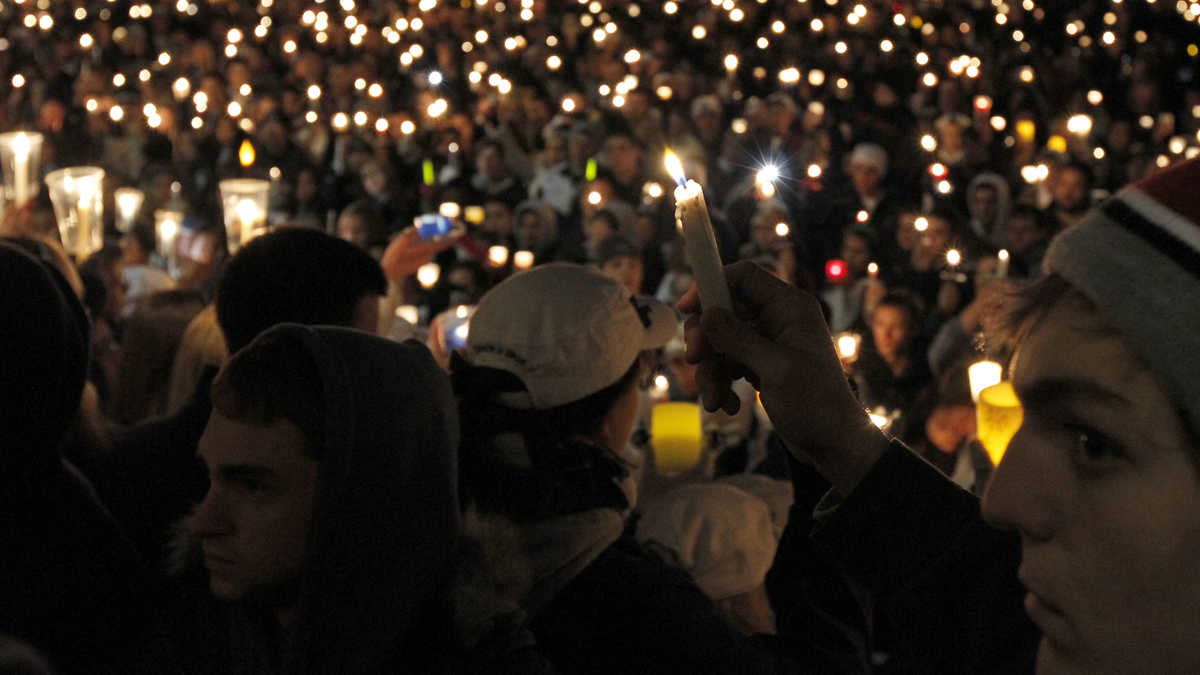  People hold a candlelight vigil to support sex abuse victims in front of the Old Main building on the Penn State Campus in November 2011 in State College, Pa. The state  Senate will take up a measure to reduce the size of Penn State's Board of Trustees, thereby responding to criticisms of how the university handled the Jerry Sandusky child sex abuse case.  (AP Photo/Alex Brandon) 