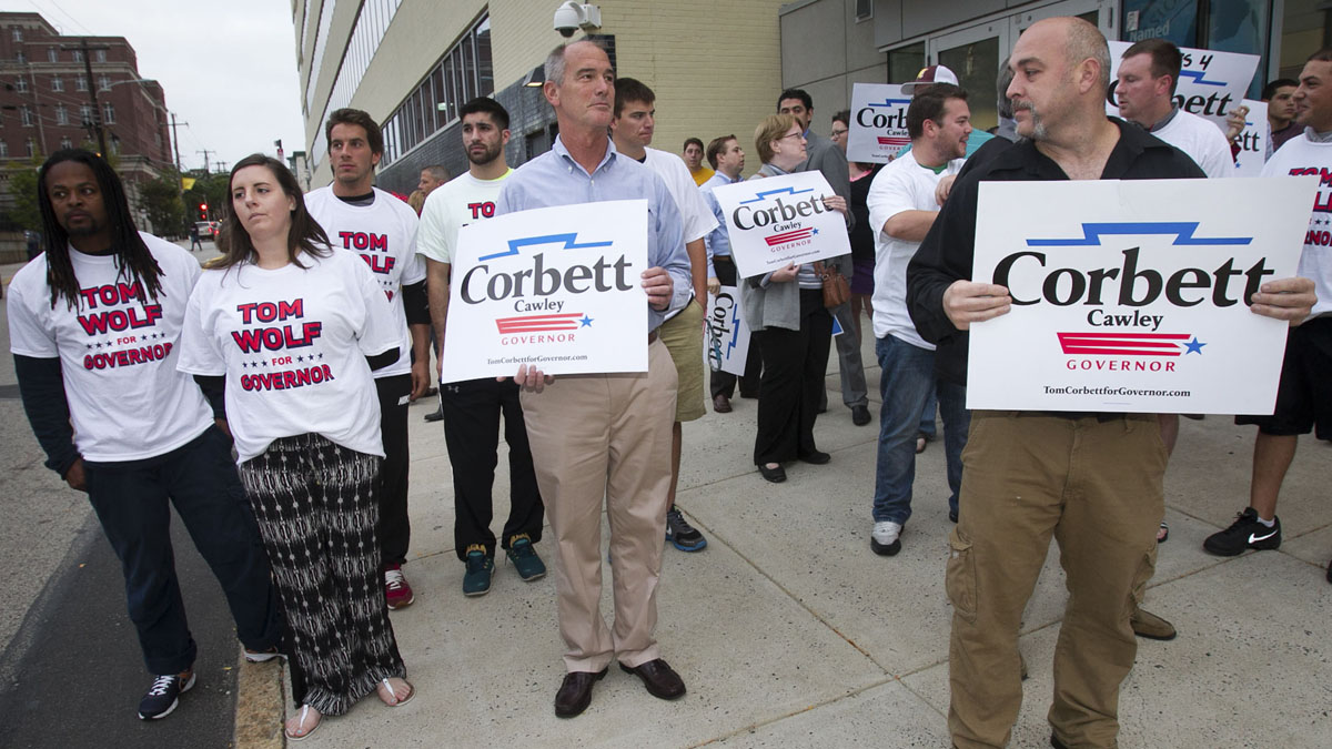  Making their sentiments known, supporters for Gov. Tom Corbett and candidate Tom Wolf gather early this month in Philadelphia as the candidates debate at 