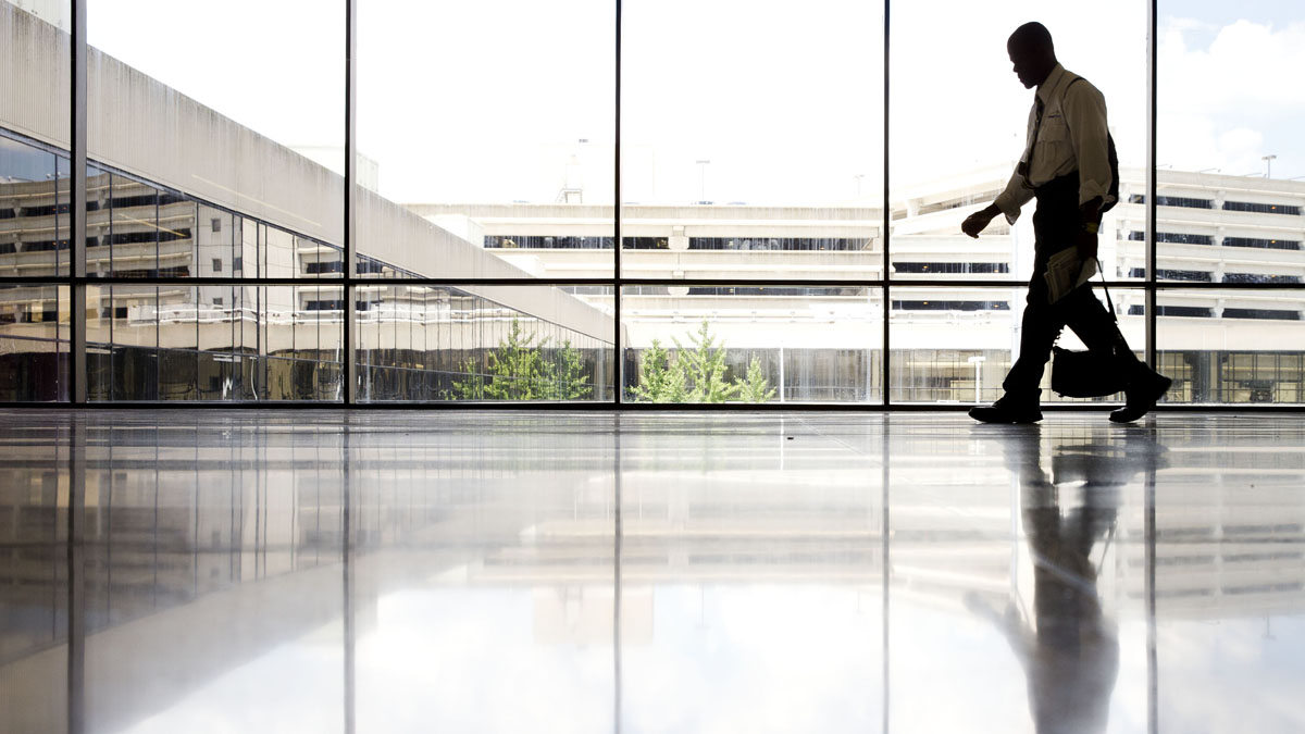 A man walks through a terminal at the Philadelphia International Airport in July. The airport's new chief operating officer faces the challenge of providing a speedy and convenient trip to travelers while assuring the safety of all. (AP Photo/Matt Rourke)