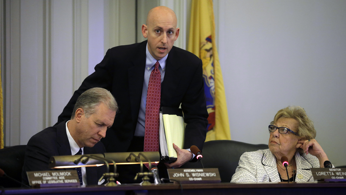  N.J. Assemblyman John S. Wisniewki, left, Sen. Loretta Weinberg, right,  listen as Reid Schar, special counsel to the Assembly committee, answers a question in Trenton, N.J., Tuesday, June 3, 2014.  (AP Photo/Mel Evans) 